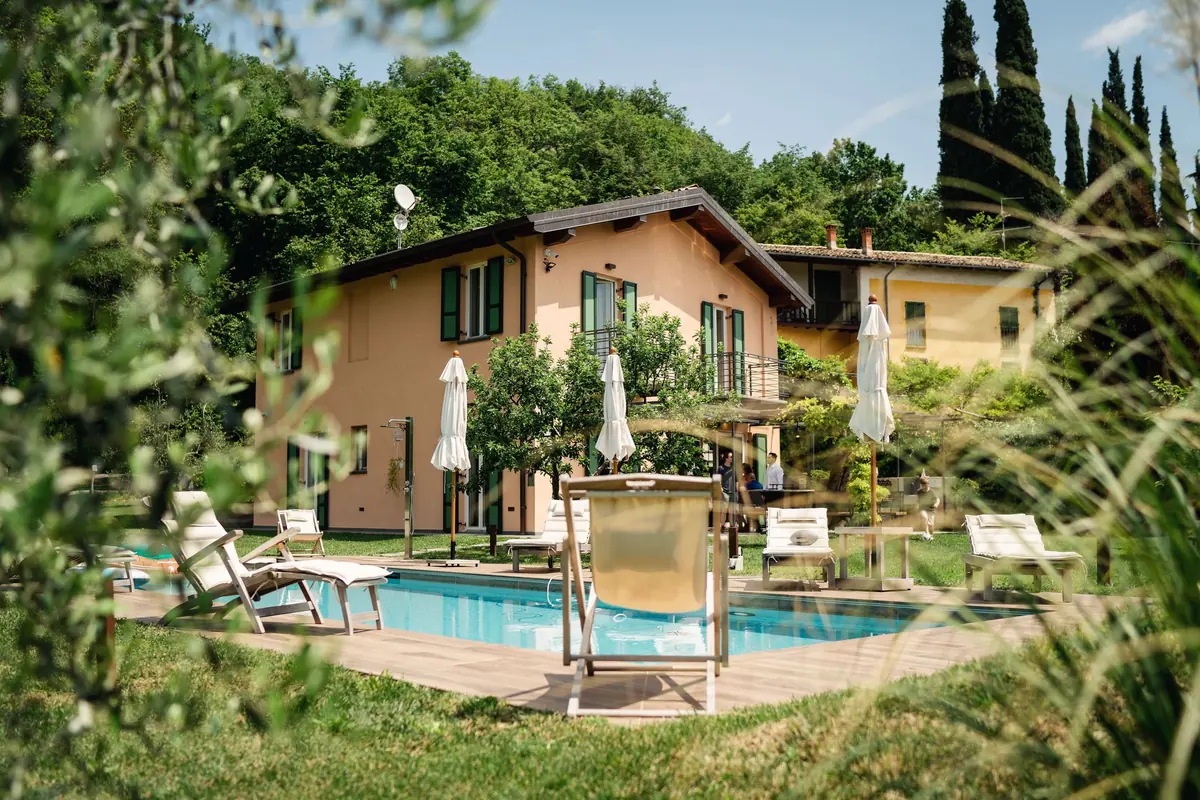 The villa and its pool among the cypresses in the Salò hills