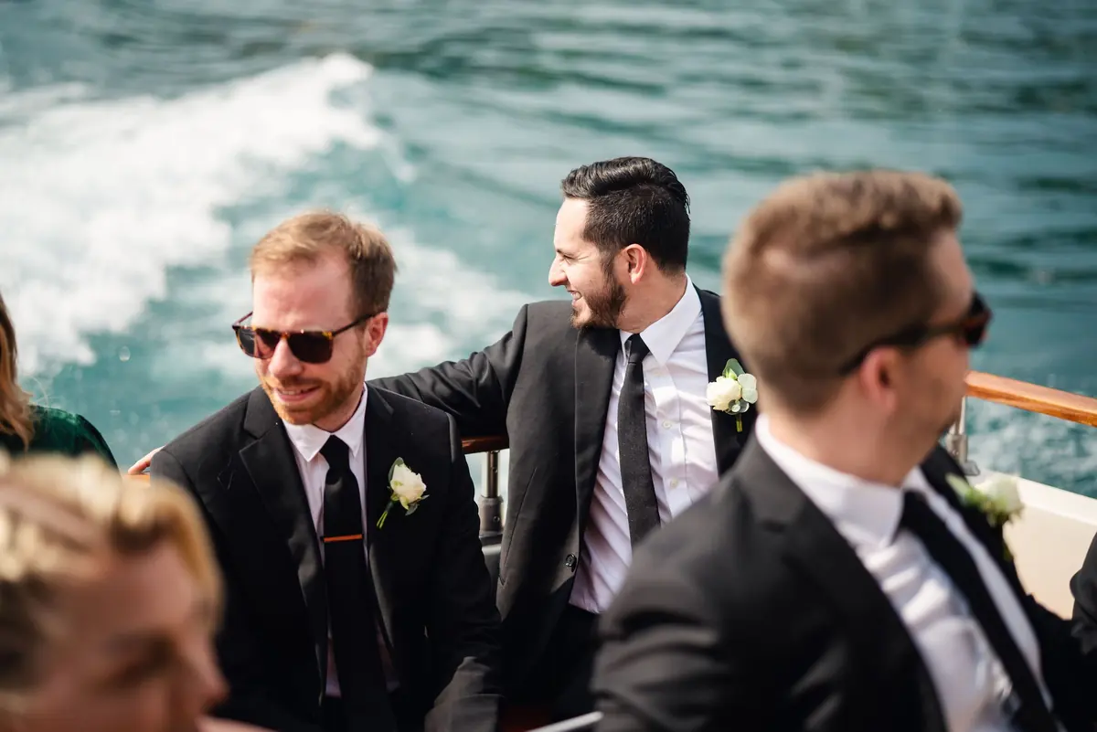 Drew and his groomsmen on the boat, with its wake behind them