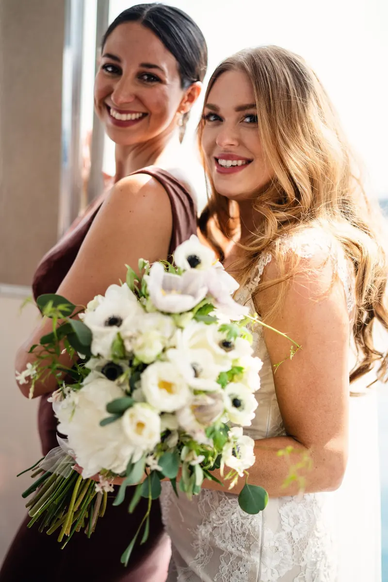Sara and a bridesmaid smiling together on the boat