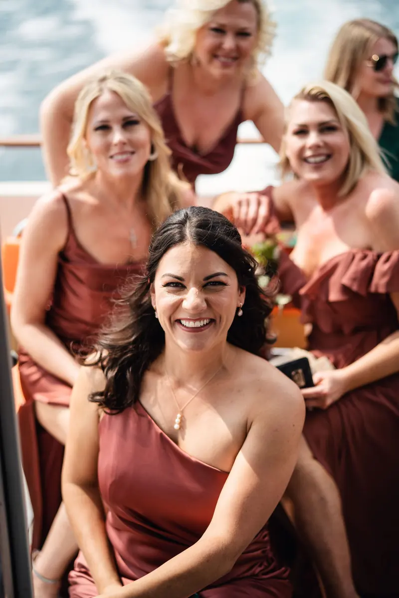 Bridesmaids laughing together on the boat