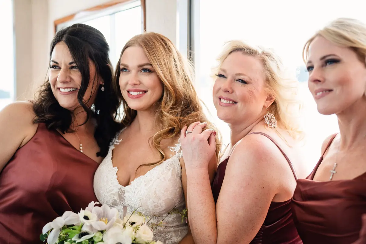 Sara and her bridesmaids close together on the boat