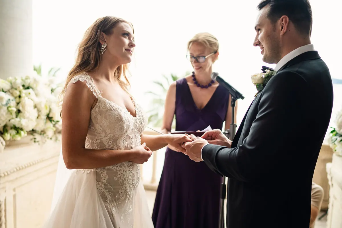 Sara and Drew exchanging rings with the officiant