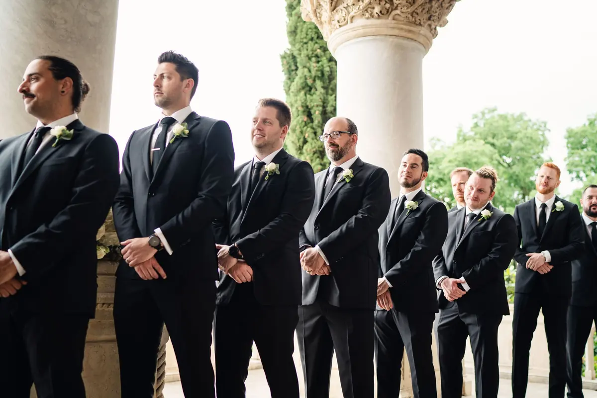 Drew's groomsmen standing in a row under the loggia