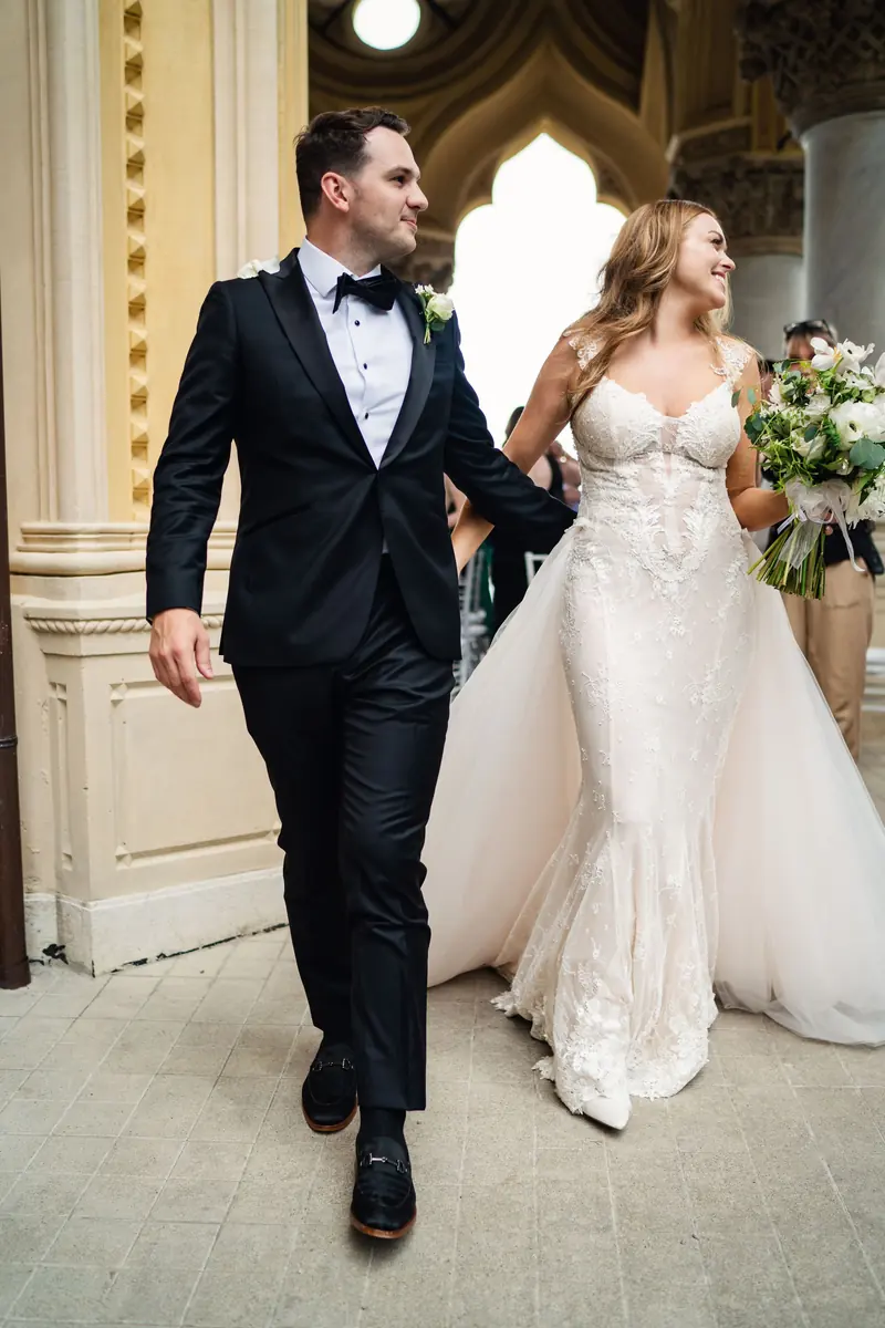 Bride and groom walking back up the aisle as newlyweds