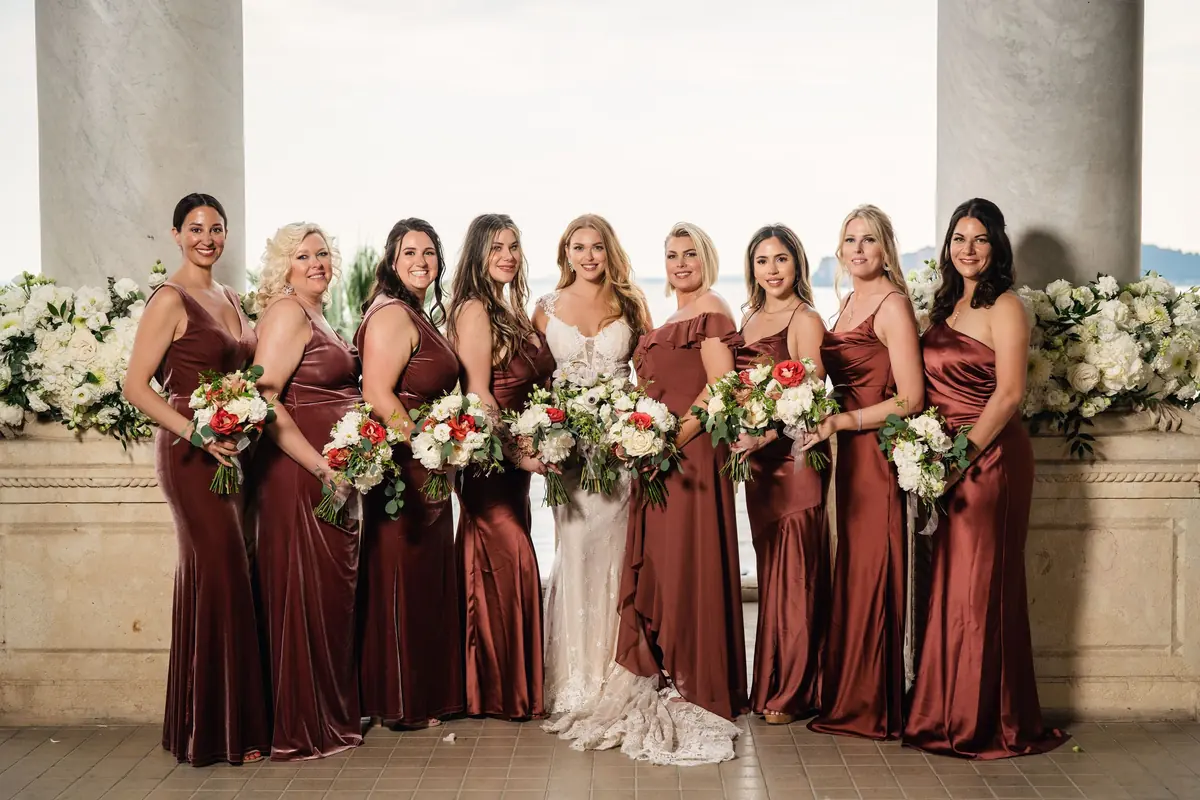 Sara with her bridesmaids in rust satin on the terrace