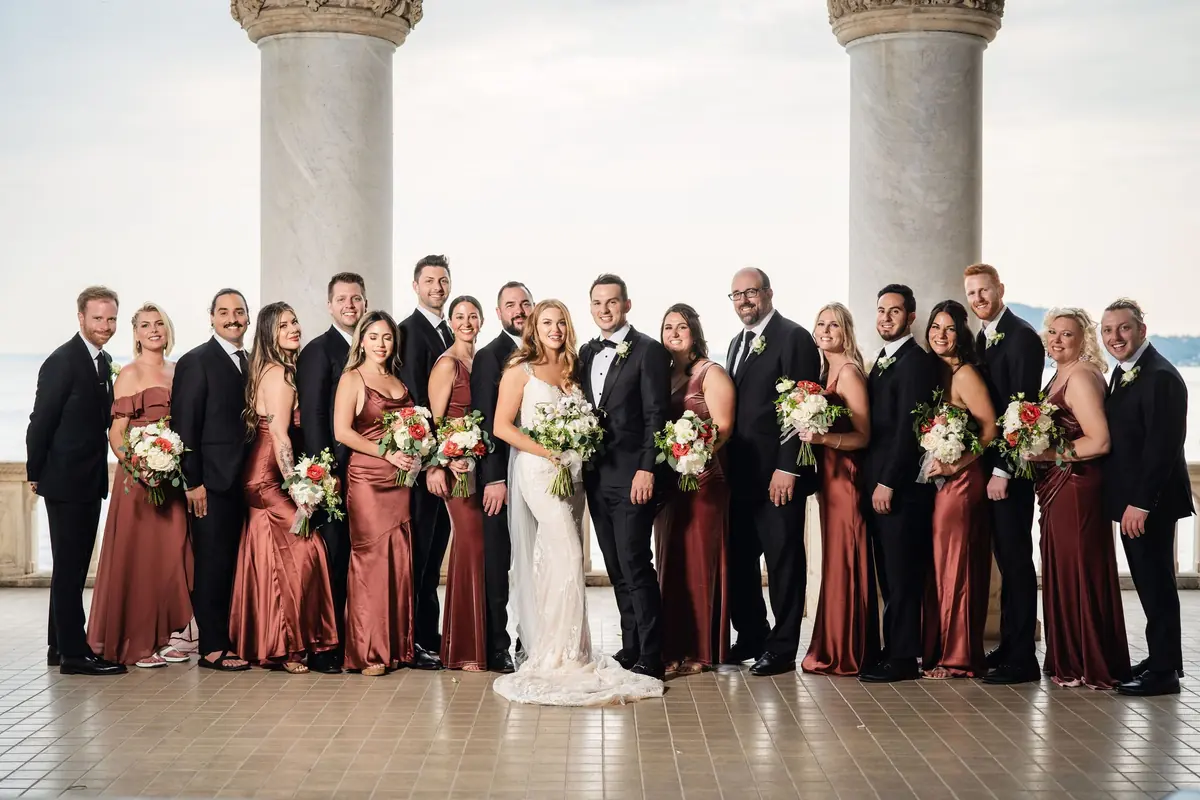 The whole wedding party on the terrace above the lake