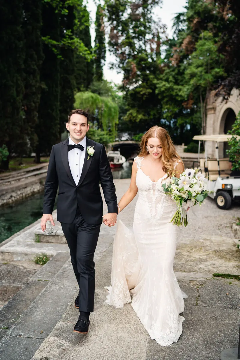 Bride and groom walking through the island gardens
