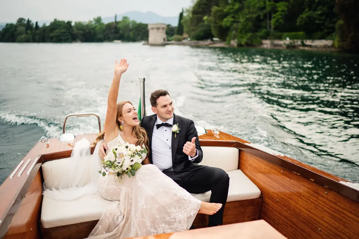 Groom raising his arm in celebration on the Riva boat