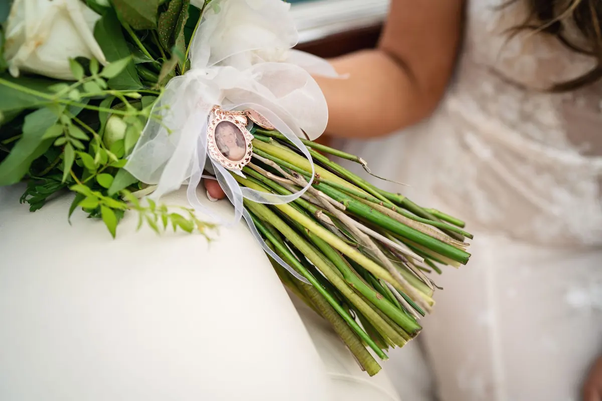 Sara's bouquet in her lap on the boat
