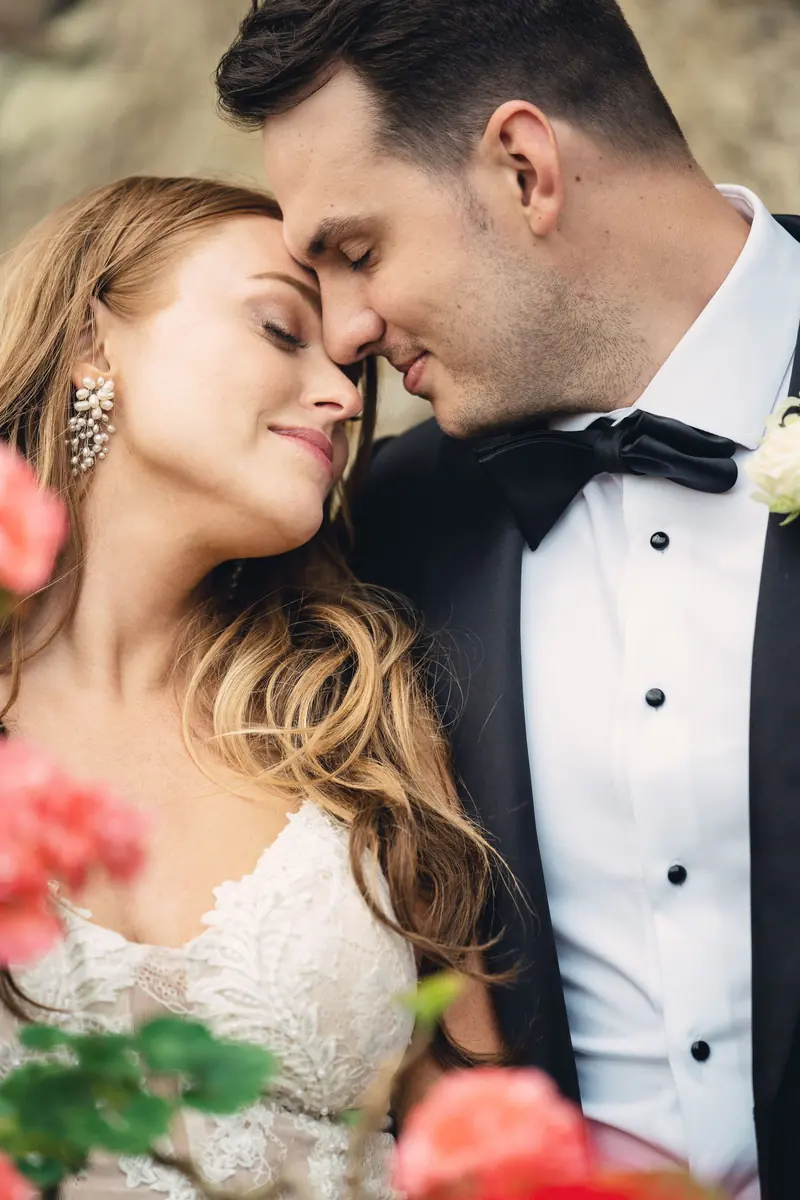 Bride and groom foreheads together in soft light