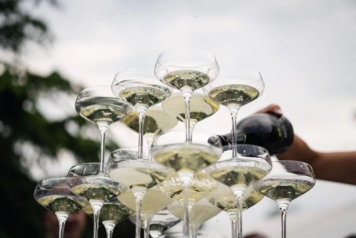 Champagne flowing down the tower of coupes